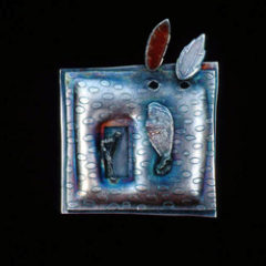 5.38 'Emergence' 1991. Brooch; white metal (oxidised), amber