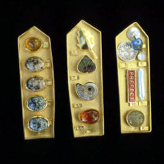 5.63 'Collecting Box' 1999. 3 Brooches; white metal (gold plated), amber, granite, mixed media, found objects