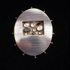 5.91 'Love Seeds - Winter' 1997. Brooch; white metal, onyx, moonstone, rock crystal, hematite, cultured pearl