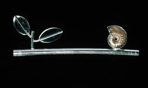 6.49 'Balance' 2000. Brooch; white metal, fossil